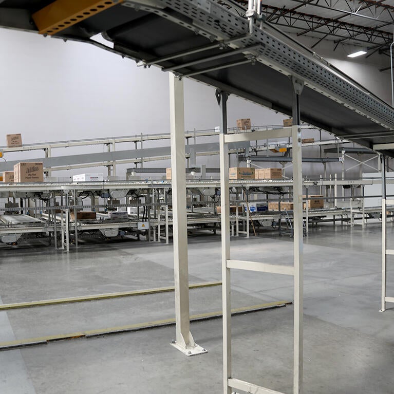 Conveyor belts moving paper products in a factory