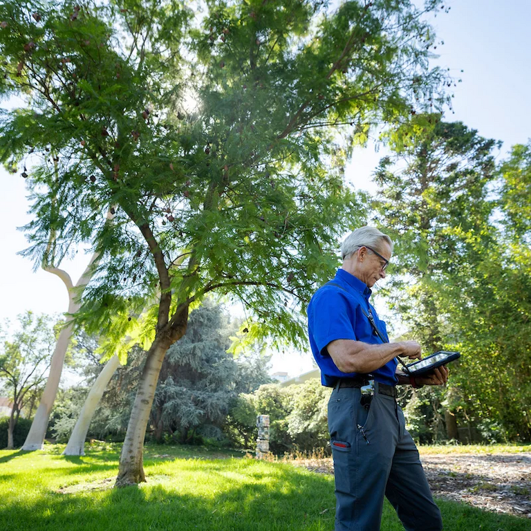 Landscape supervisor Mark Jones using a tablet