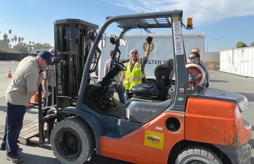 Forklift outdoor training Instructor pointing to parts of a forklift for hands-on training